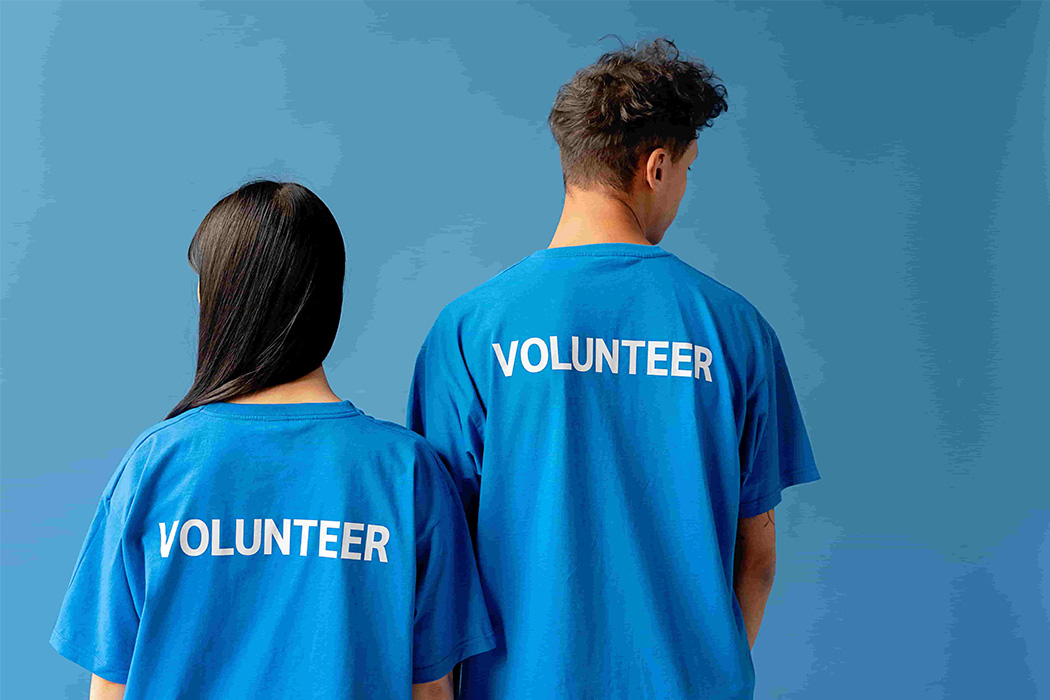 Image of a man and a woman in volunteer t-shirts